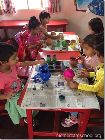 Girls and boys busy painting matki and decorating their bansuri (1)