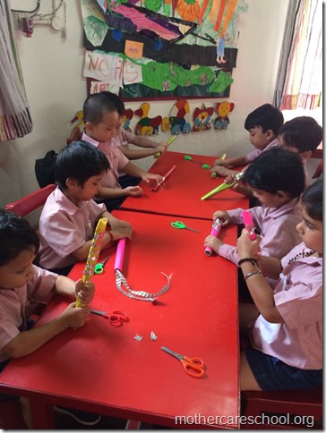 Girls and boys busy painting matki and decorating their bansuri (2)
