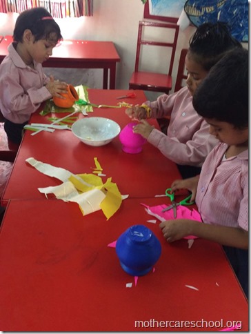Girls and boys busy painting matki and decorating their bansuri (3)
