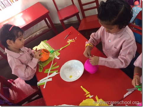 Girls and boys busy painting matki and decorating their bansuri (4)