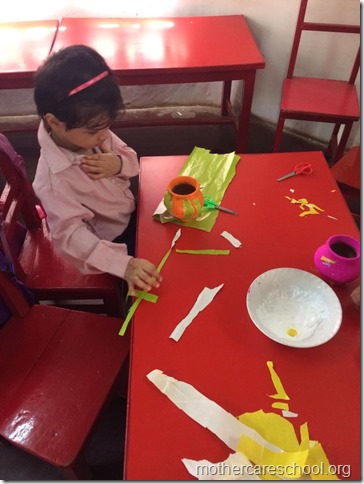 Girls and boys busy painting matki and decorating their bansuri (5)